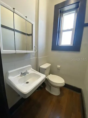 a bathroom with a sink toilet and mirror