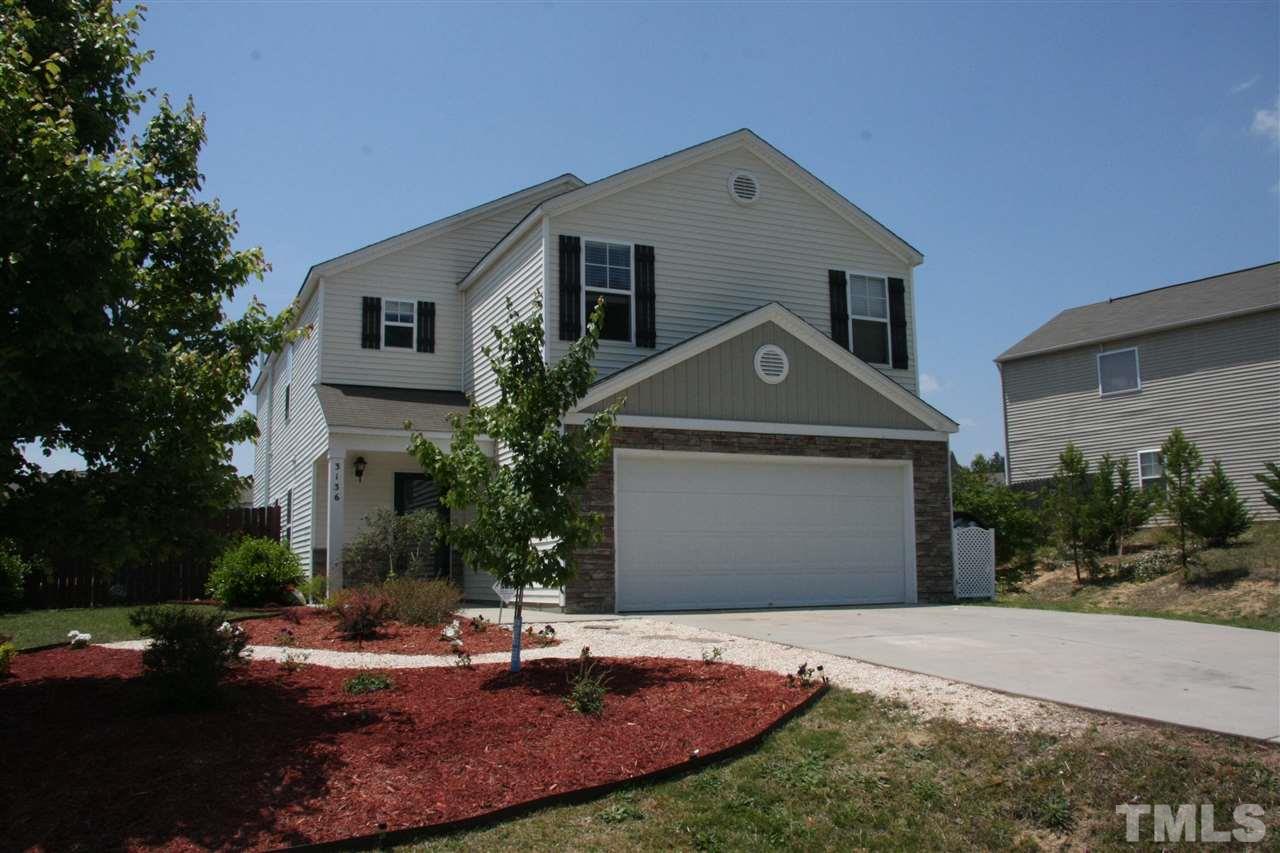 3136 Varcroft Road Knightdale, NC 27545 - Photo 1 of 23 a front view of house with yard and trees in the background