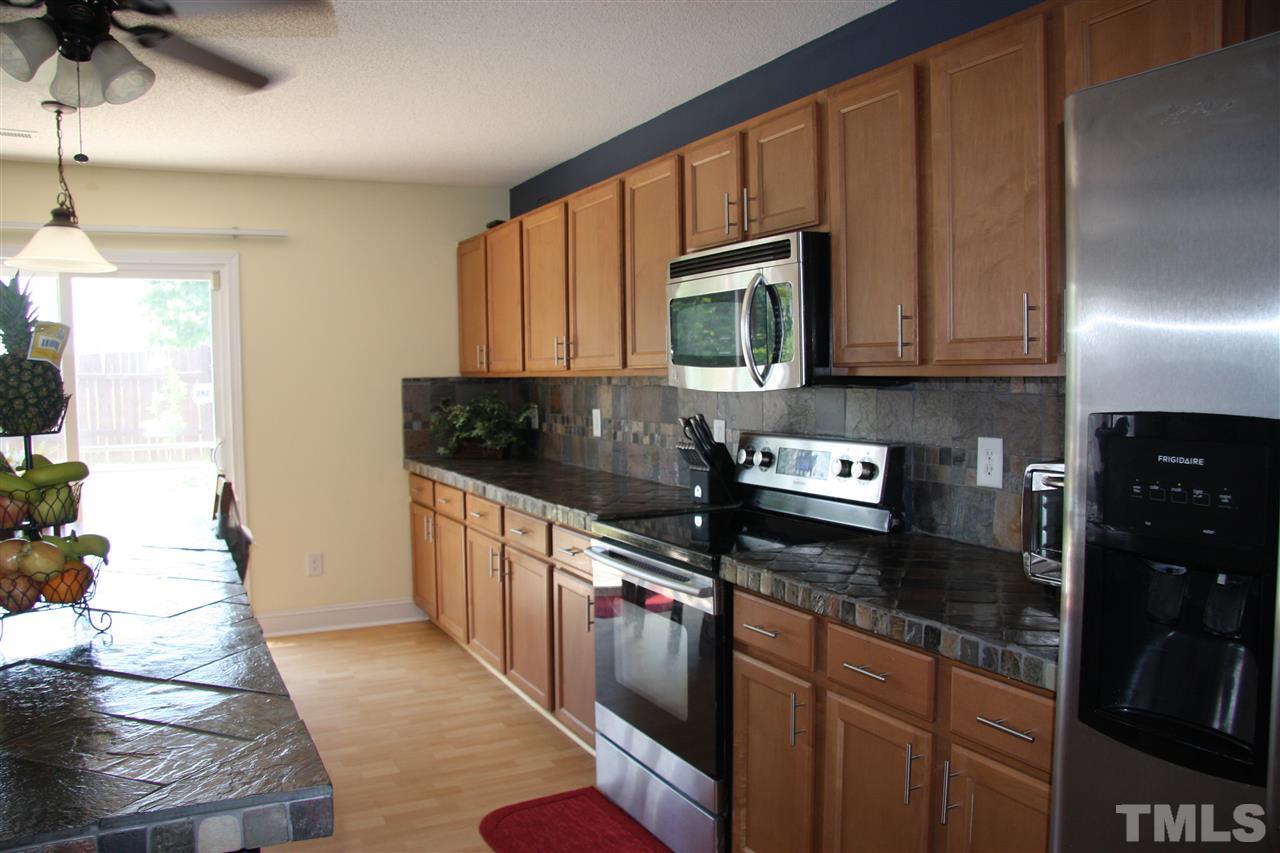 3136 Varcroft Road Knightdale, NC 27545 - Photo 12 of 23 a kitchen with stainless steel appliances granite countertop a stove a sink and a microwave