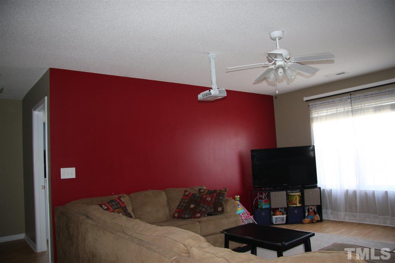 3136 Varcroft Road Knightdale, NC 27545 - Photo 13 of 23 a living room with furniture and a flat screen tv