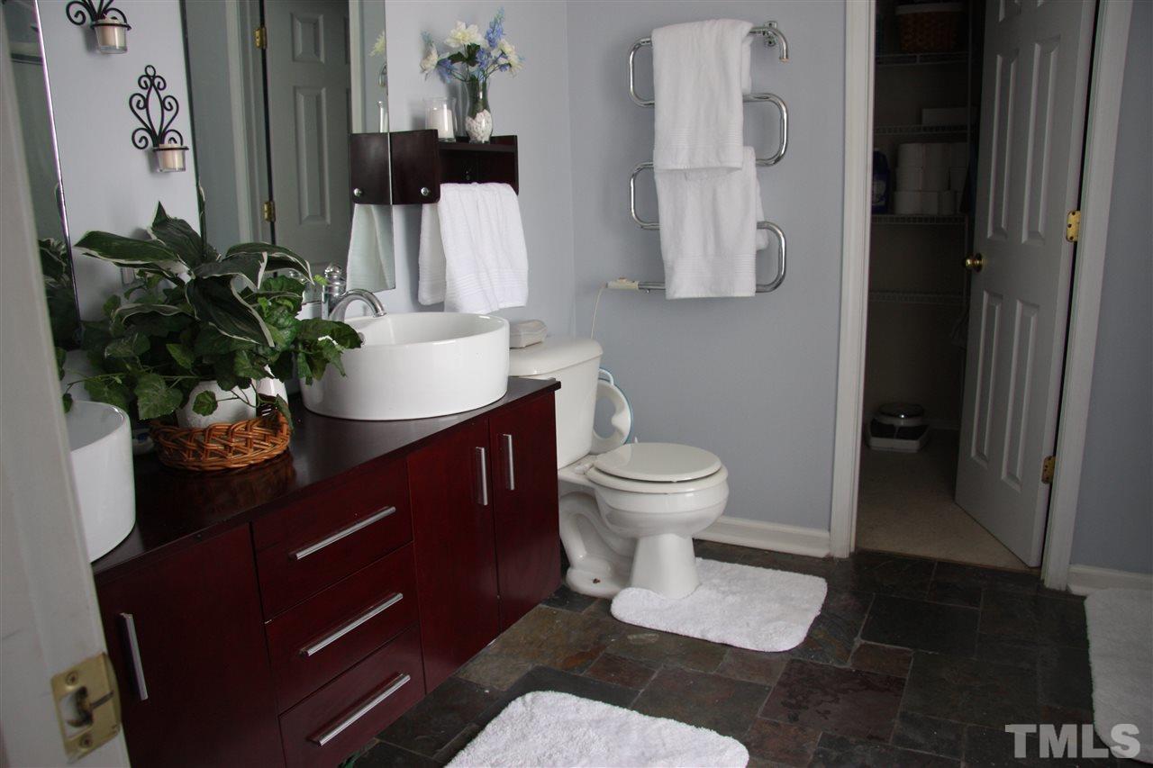 3136 Varcroft Road Knightdale, NC 27545 - Photo 19 of 23 a bathroom with a sink toilet and mirror