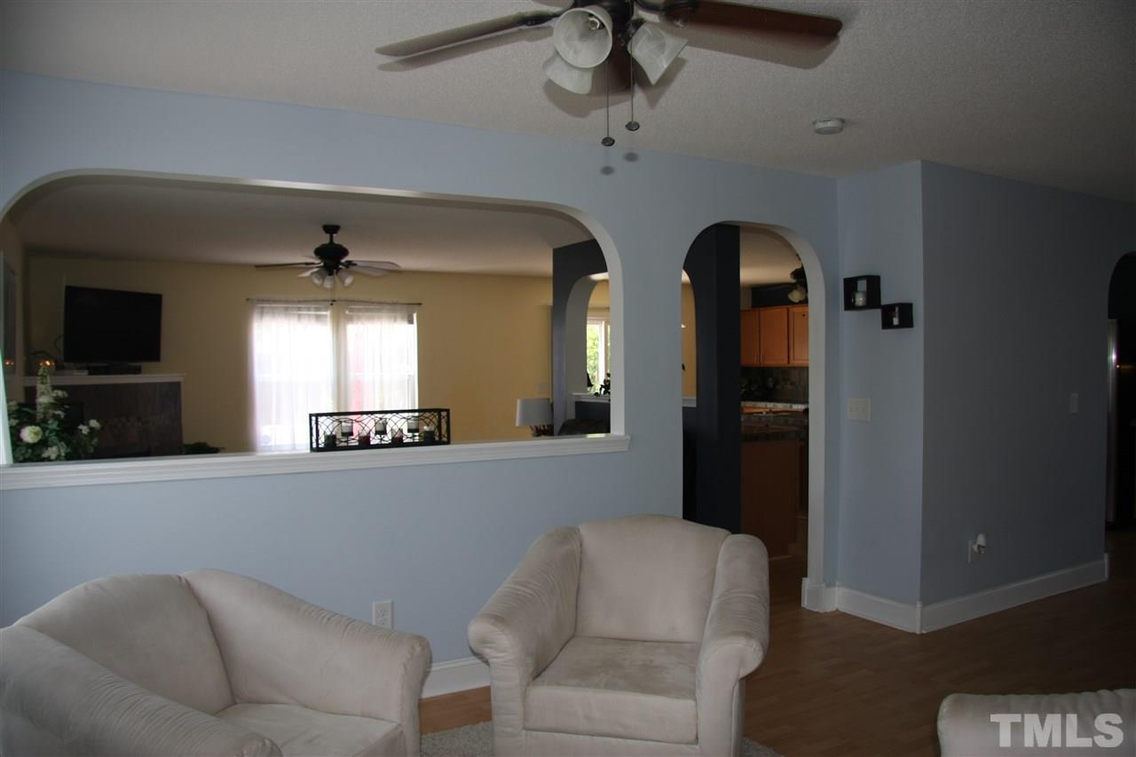 3136 Varcroft Road Knightdale, NC 27545 - Photo 3 of 23 a living room with furniture and a flat screen tv
