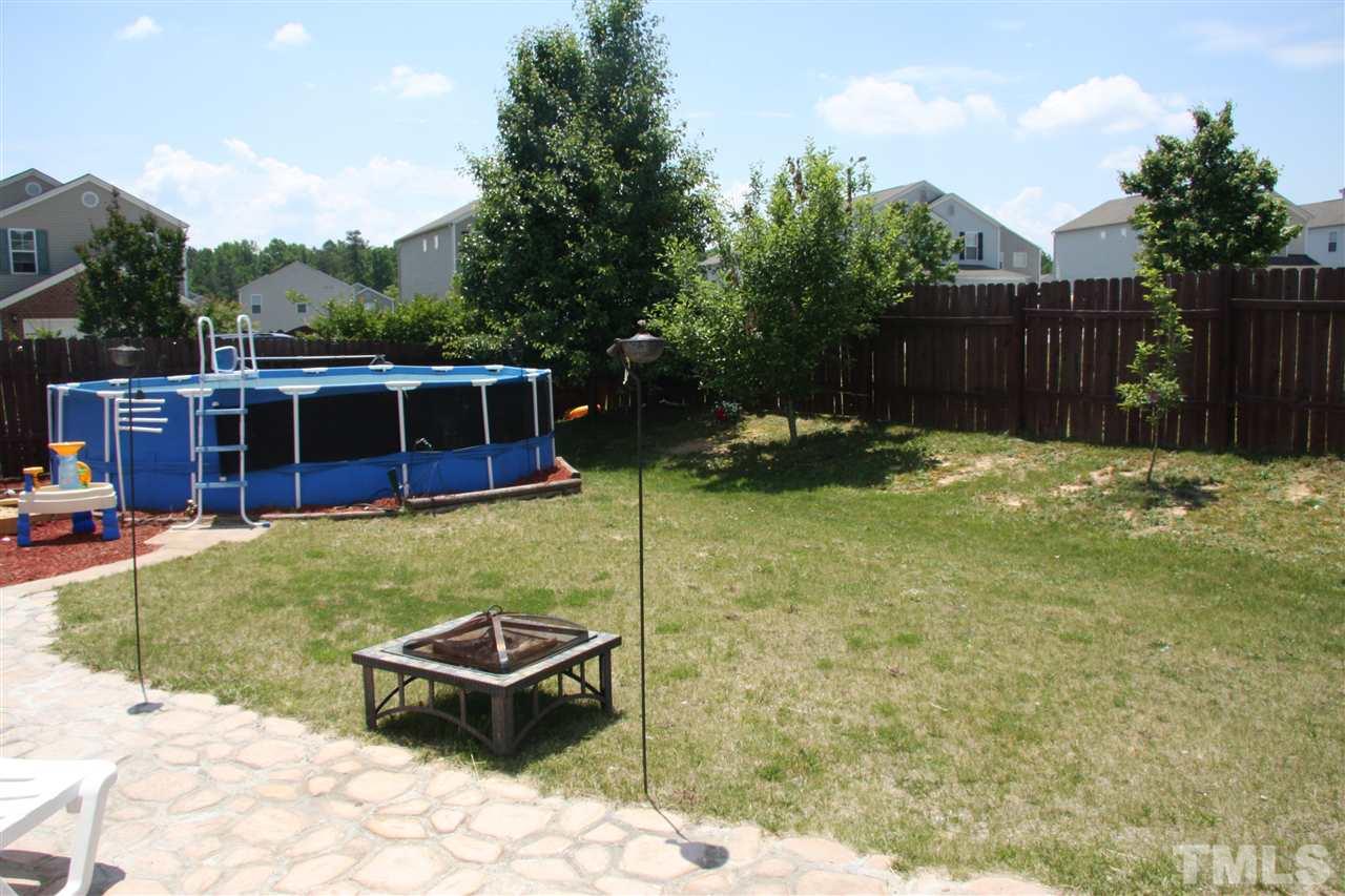 3136 Varcroft Road Knightdale, NC 27545 - Photo 21 of 23 a backyard of a house with yard table and chairs