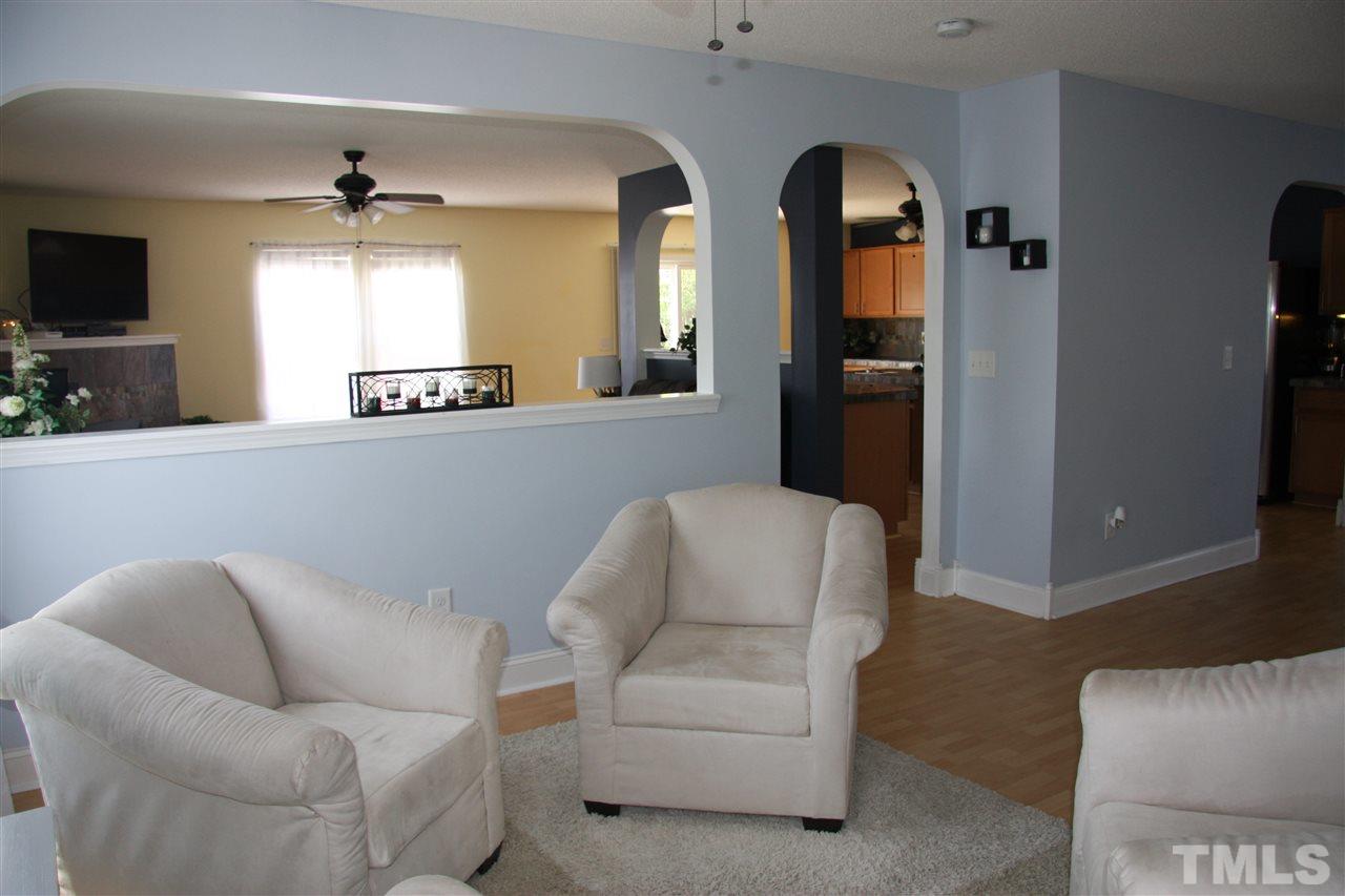 3136 Varcroft Road Knightdale, NC 27545 - Photo 6 of 23 a living room with furniture and a flat screen tv