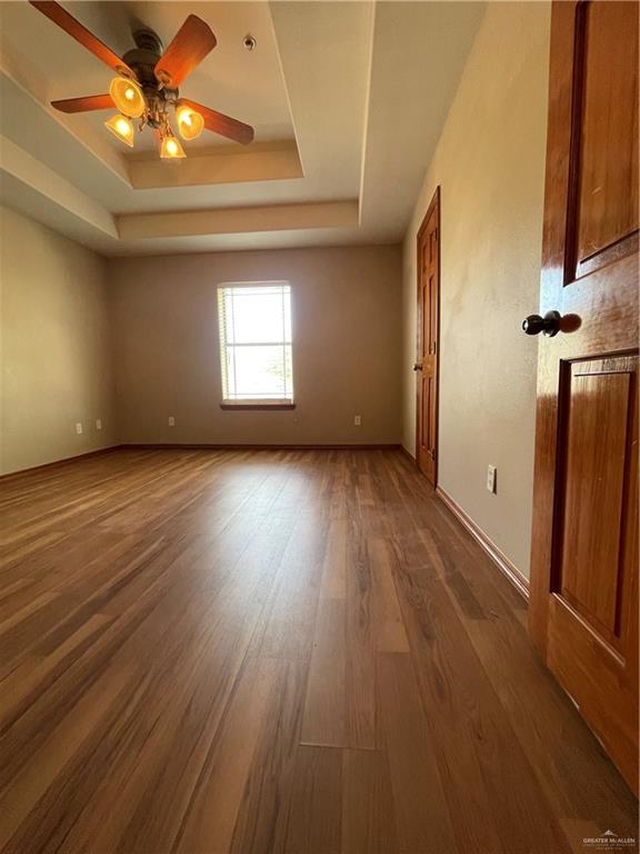 1305 East Olympia Avenue, Unit A McAllen, TX 78503 - Photo 12 of 13 a view of empty room with wooden floor and fan