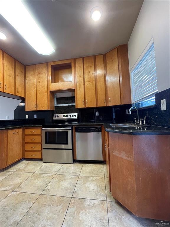 1305 East Olympia Avenue, Unit A McAllen, TX 78503 - Photo 3 of 13 a kitchen with granite countertop a stove and a sink