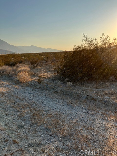 13329 Fremontia Road Cabazon, CA 92230 - Photo 5 of 6 a view of a dry yard with wooden fence