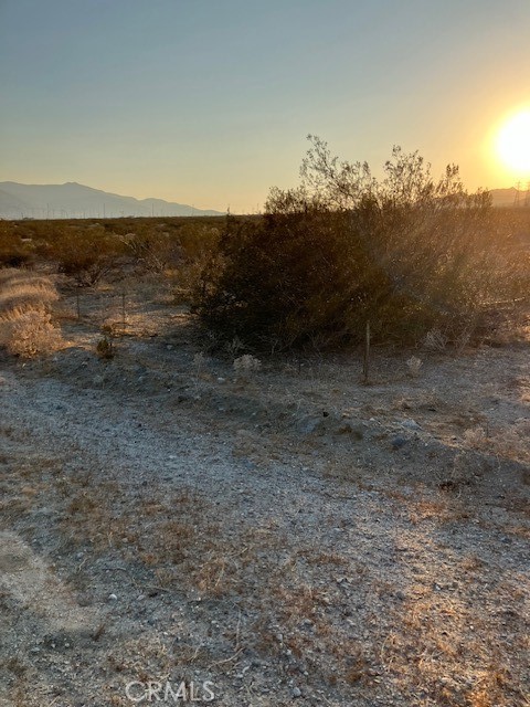 13329 Fremontia Road Cabazon, CA 92230 - Photo 6 of 6 a view of a dry yard with wooden fence
