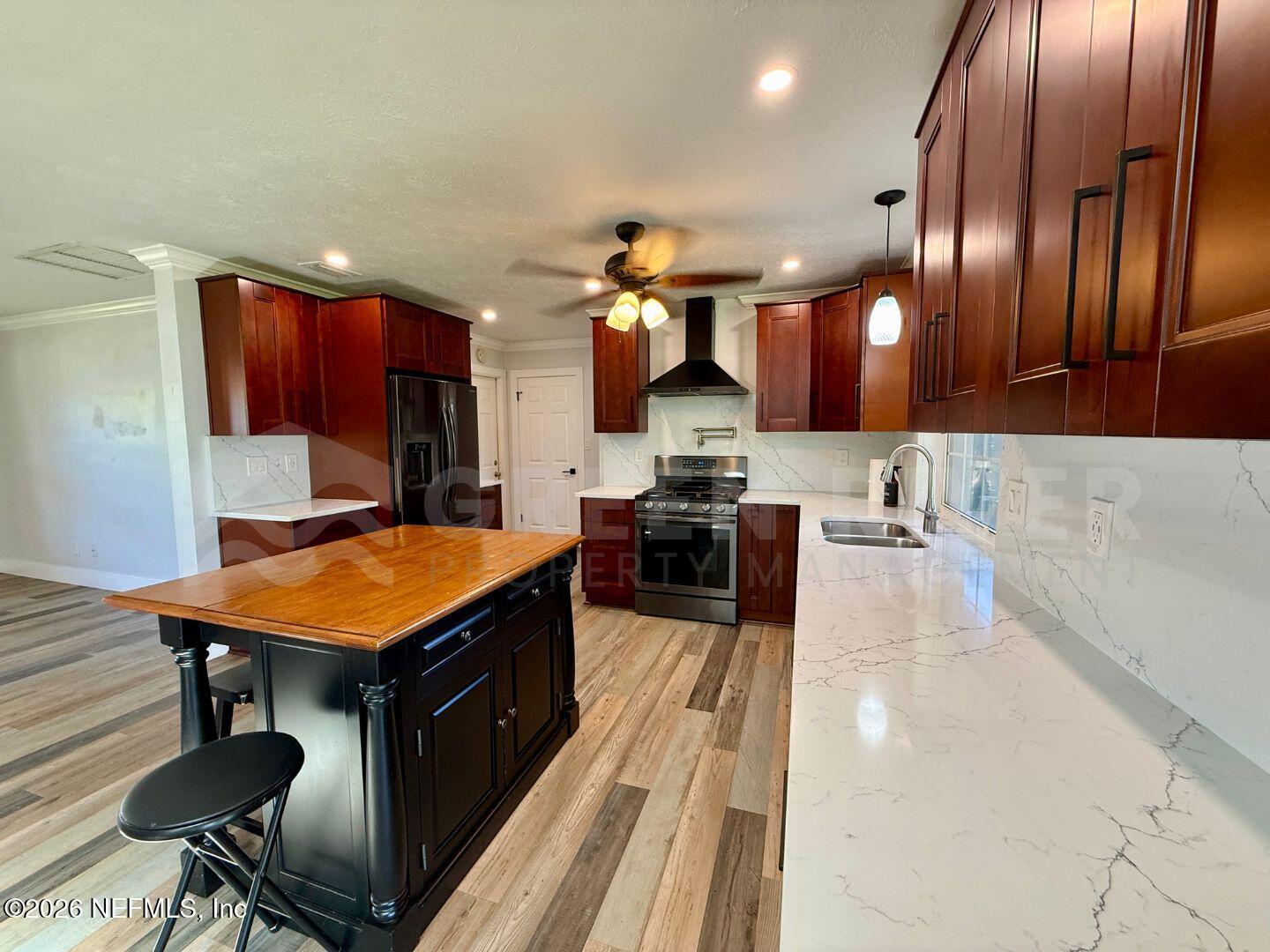 2 Fairway Road Jacksonville Beach, FL 32250 - Photo 12 of 39 a kitchen with stainless steel appliances granite countertop a sink a stove and a wooden floors