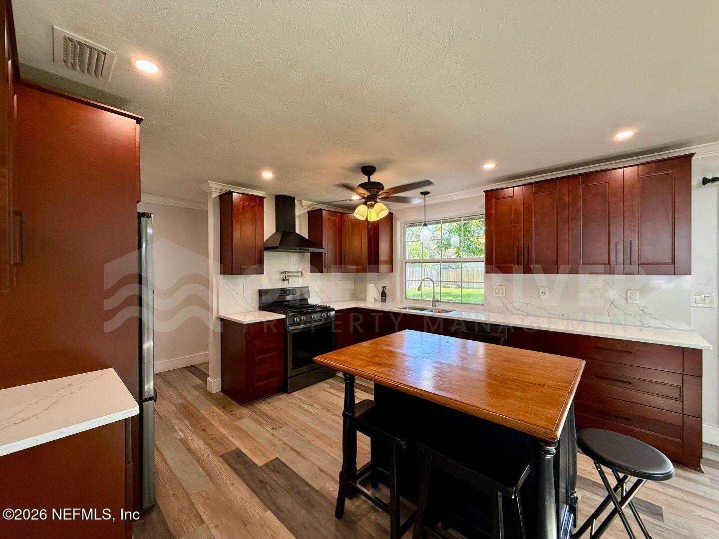 2 Fairway Road Jacksonville Beach, FL 32250 - Photo 13 of 39 a large kitchen with a table and chairs in it