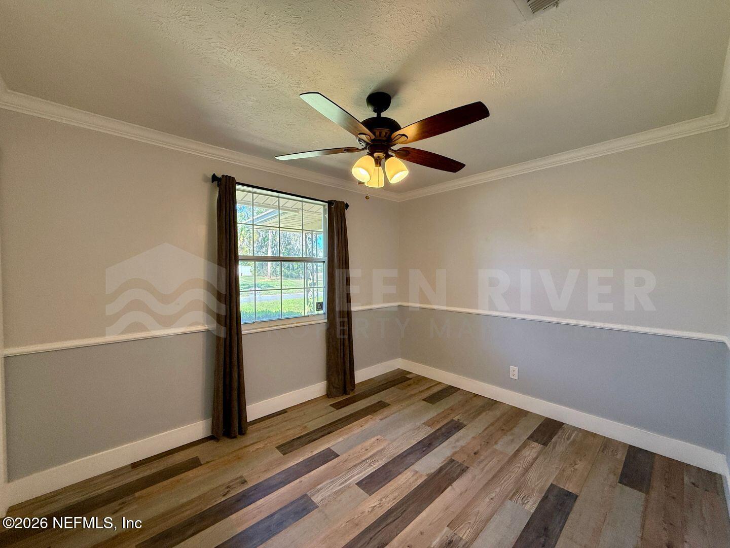 2 Fairway Road Jacksonville Beach, FL 32250 - Photo 23 of 39 a view of empty room with wooden floor and fan