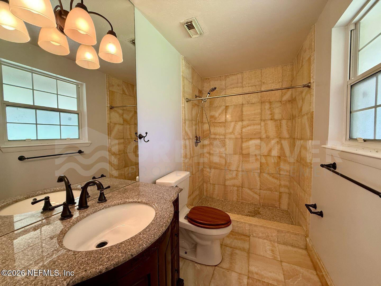 2 Fairway Road Jacksonville Beach, FL 32250 - Photo 32 of 39 a bathroom with a sink a toilet and shower
