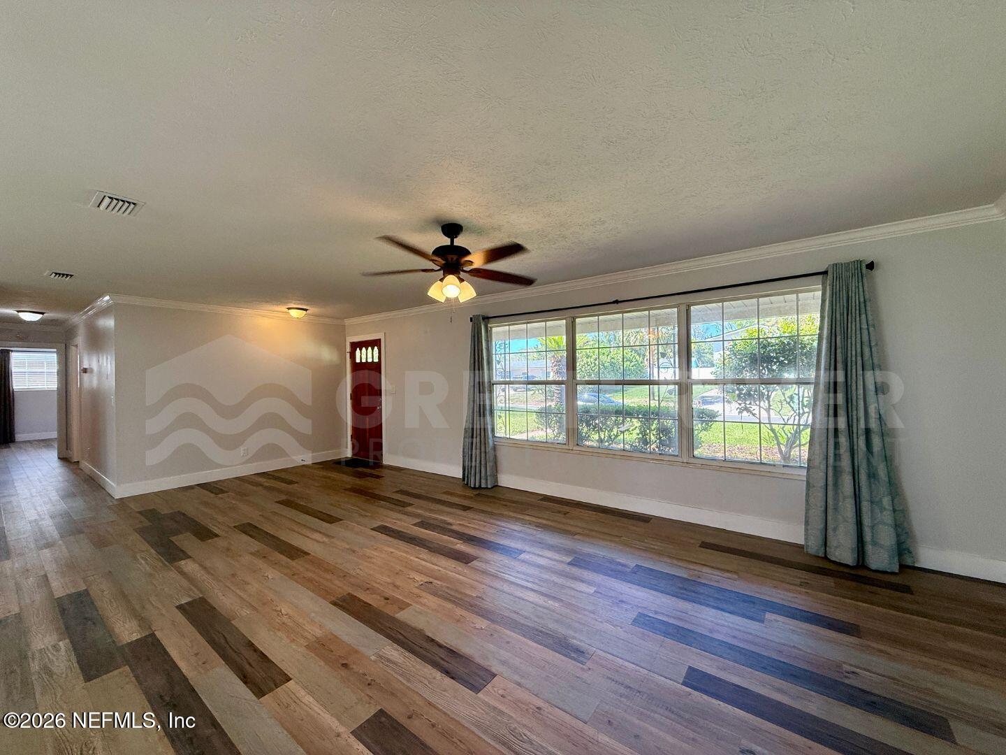 2 Fairway Road Jacksonville Beach, FL 32250 - Photo 7 of 39 a view of an empty room with wooden floor and a window