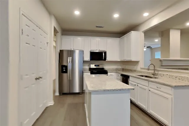 a kitchen with a sink stainless steel appliances and cabinets