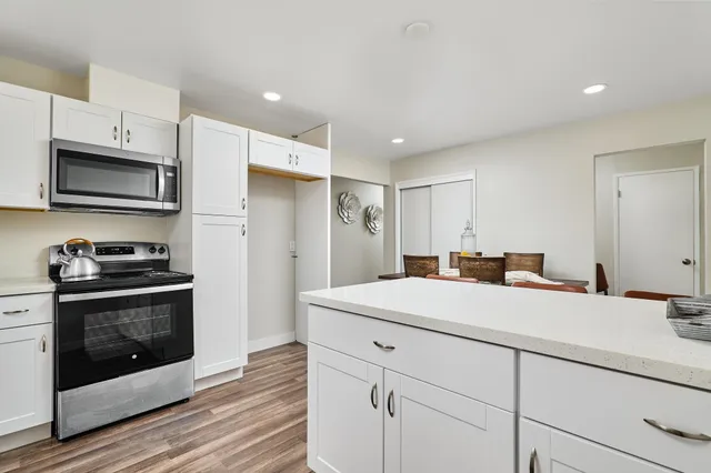 a kitchen with stainless steel appliances a stove microwave and refrigerator