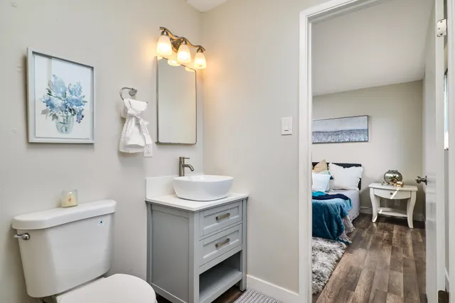 a bathroom with a toilet a sink and mirror