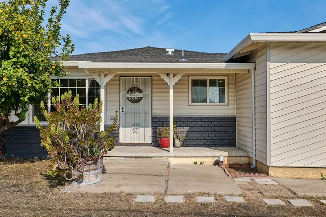 a front view of a house with garden