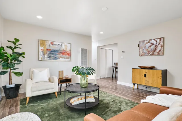 a living room with furniture and a potted plant