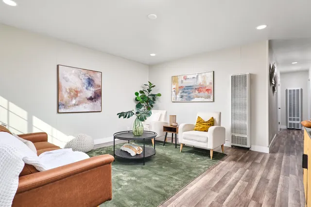 a living room with furniture and wooden floor