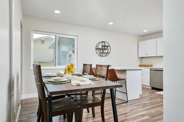 a view of a dining room with furniture and wooden floor