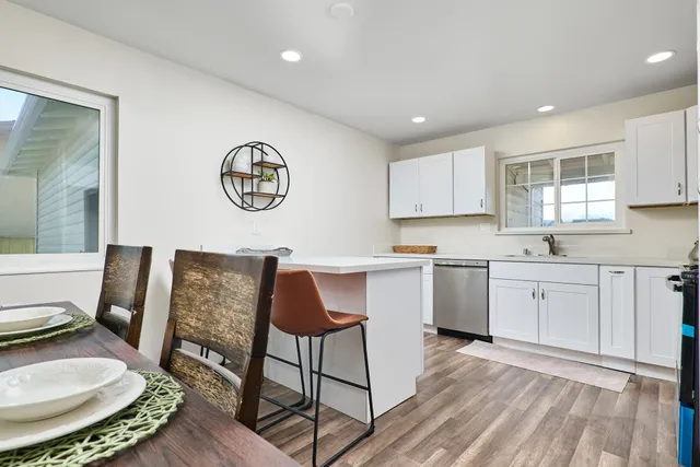 a kitchen with a sink cabinets and wooden floor