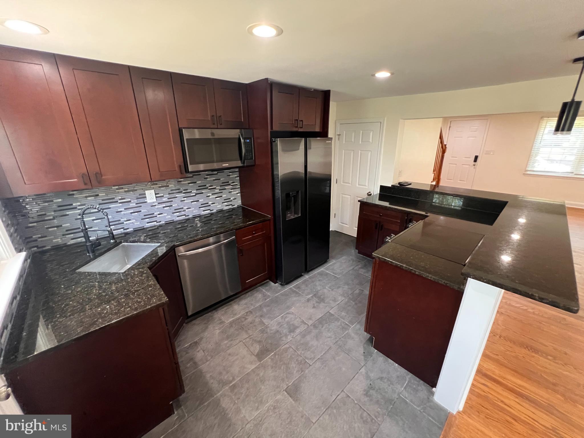 1583 Doxbury Road Towson, MD 21286 - Photo 7 of 31 a kitchen with stainless steel appliances granite countertop a stove a sink and a microwave