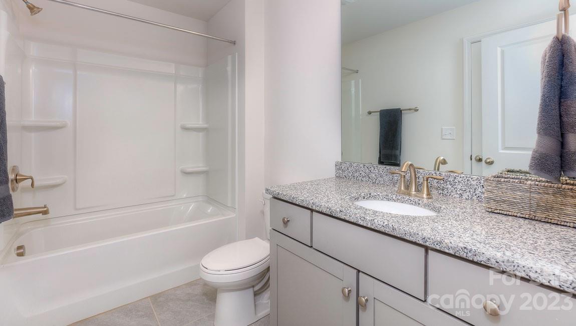 43 Ravens Rdg Road Hendersonville, NC 28792 - Photo 24 of 27 a bathroom with a granite countertop sink toilet and shower