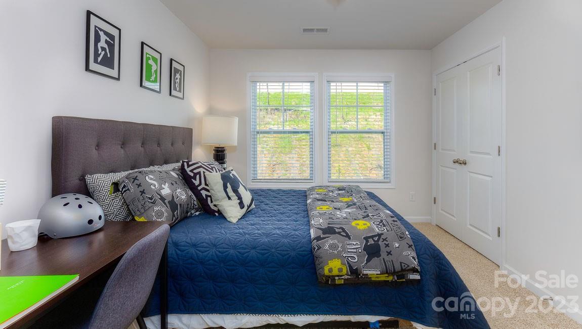 43 Ravens Rdg Road Hendersonville, NC 28792 - Photo 26 of 27 a bedroom with furniture and a wooden floor