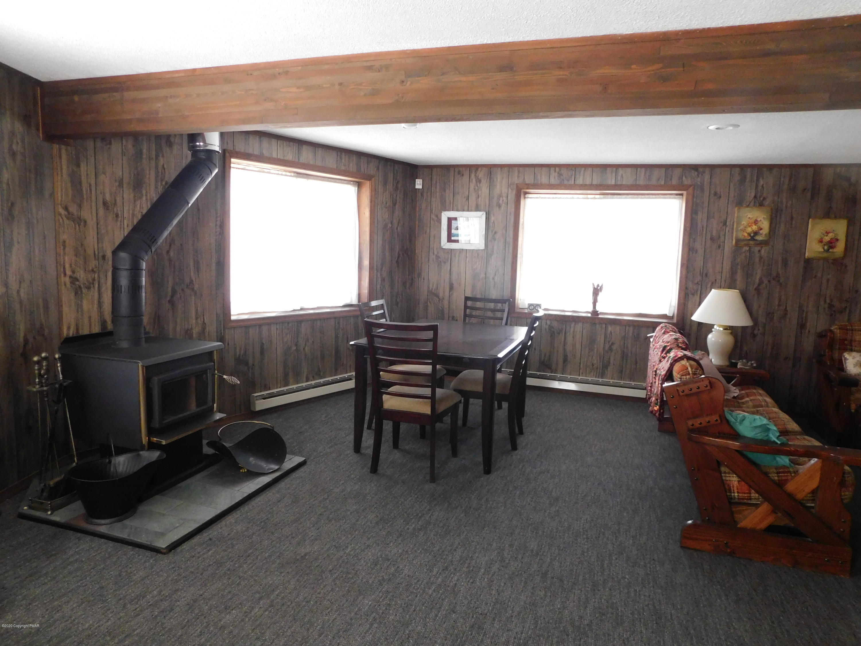 200 Canterbury Road Bushkill, PA 18324 - Photo 12 of 48 a living room with furniture a flat screen tv and a window