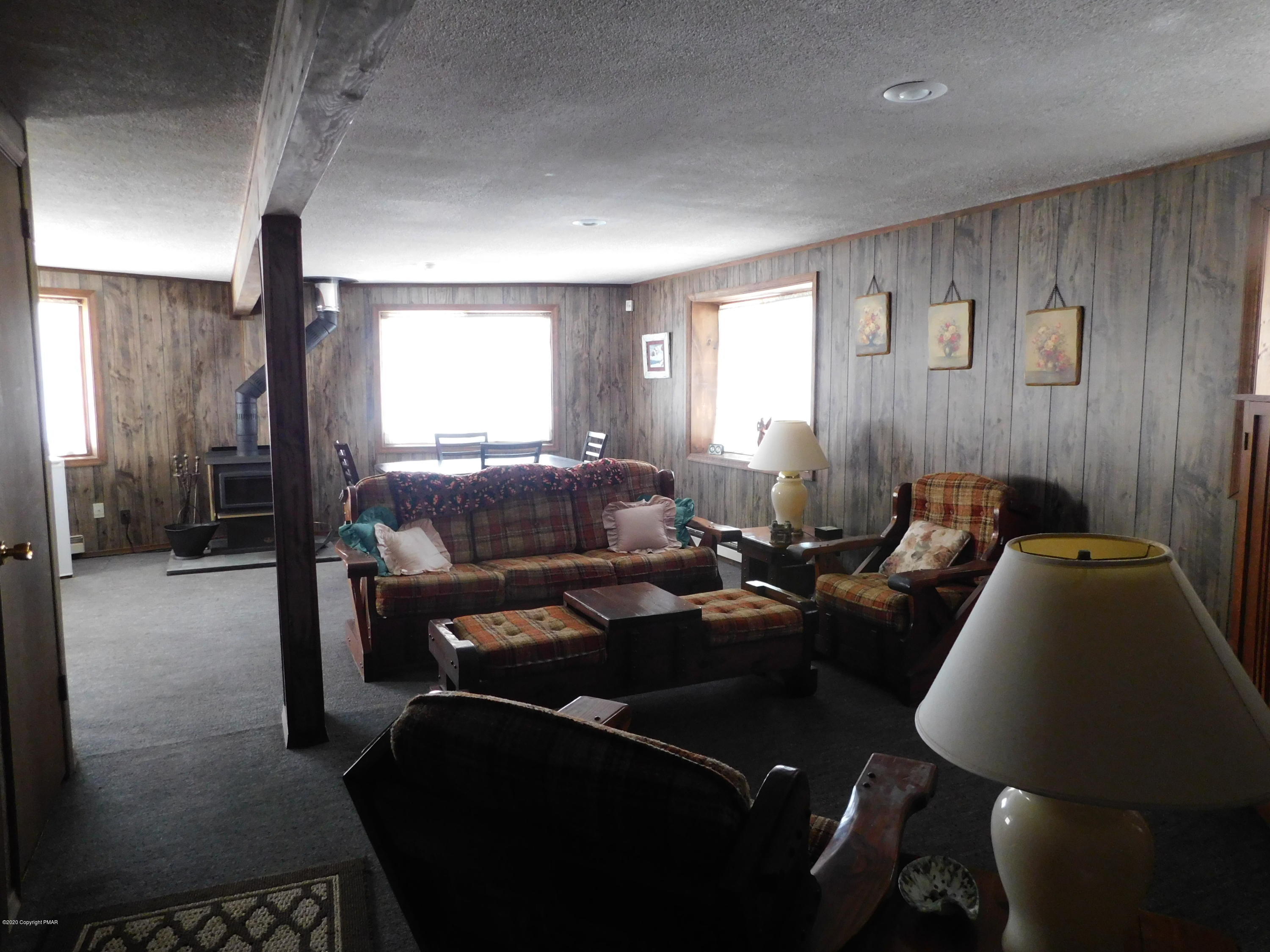 200 Canterbury Road Bushkill, PA 18324 - Photo 17 of 48 a living room with furniture a large window and a chandelier