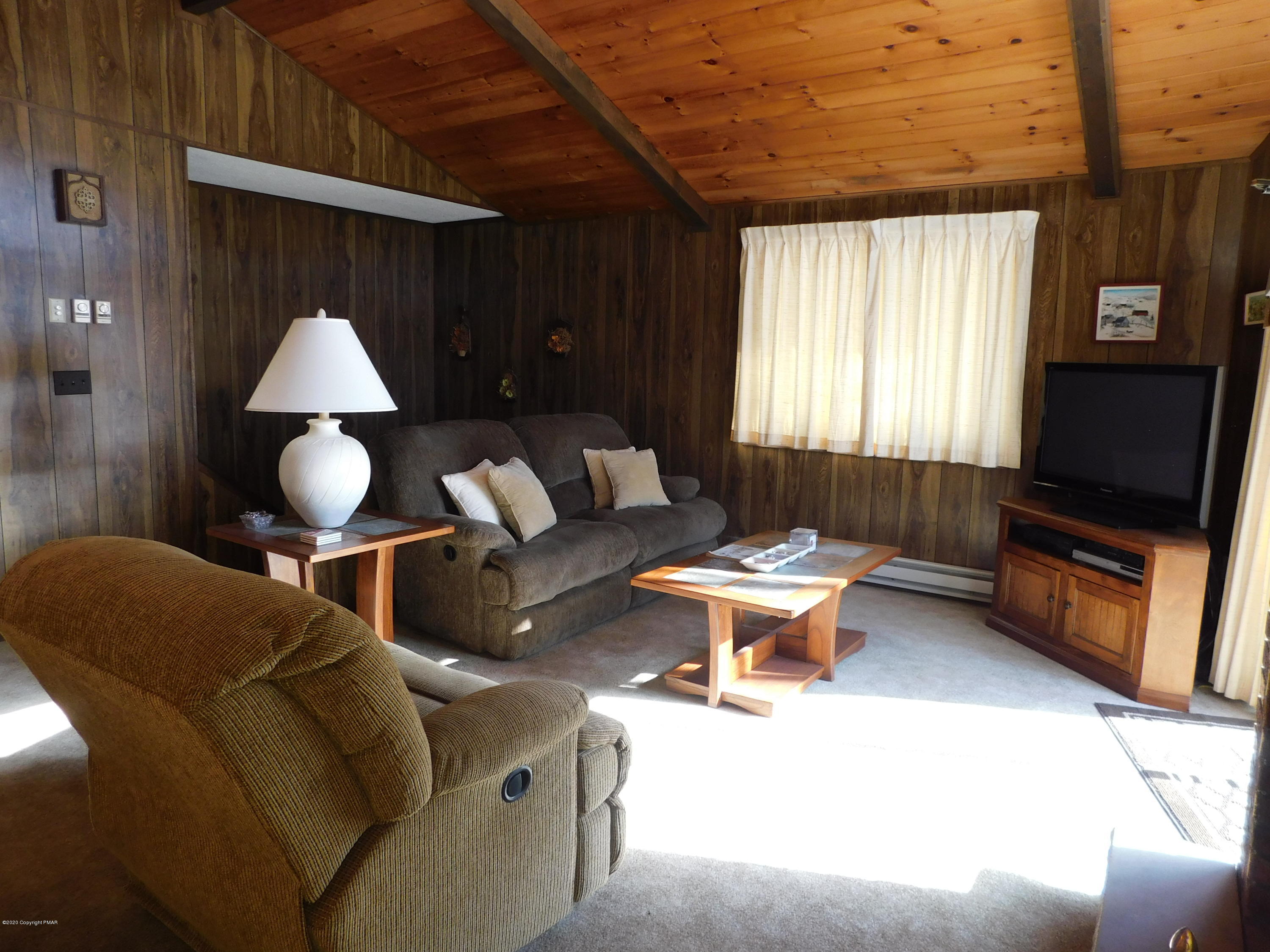 200 Canterbury Road Bushkill, PA 18324 - Photo 2 of 48 a living room with furniture and a flat screen tv