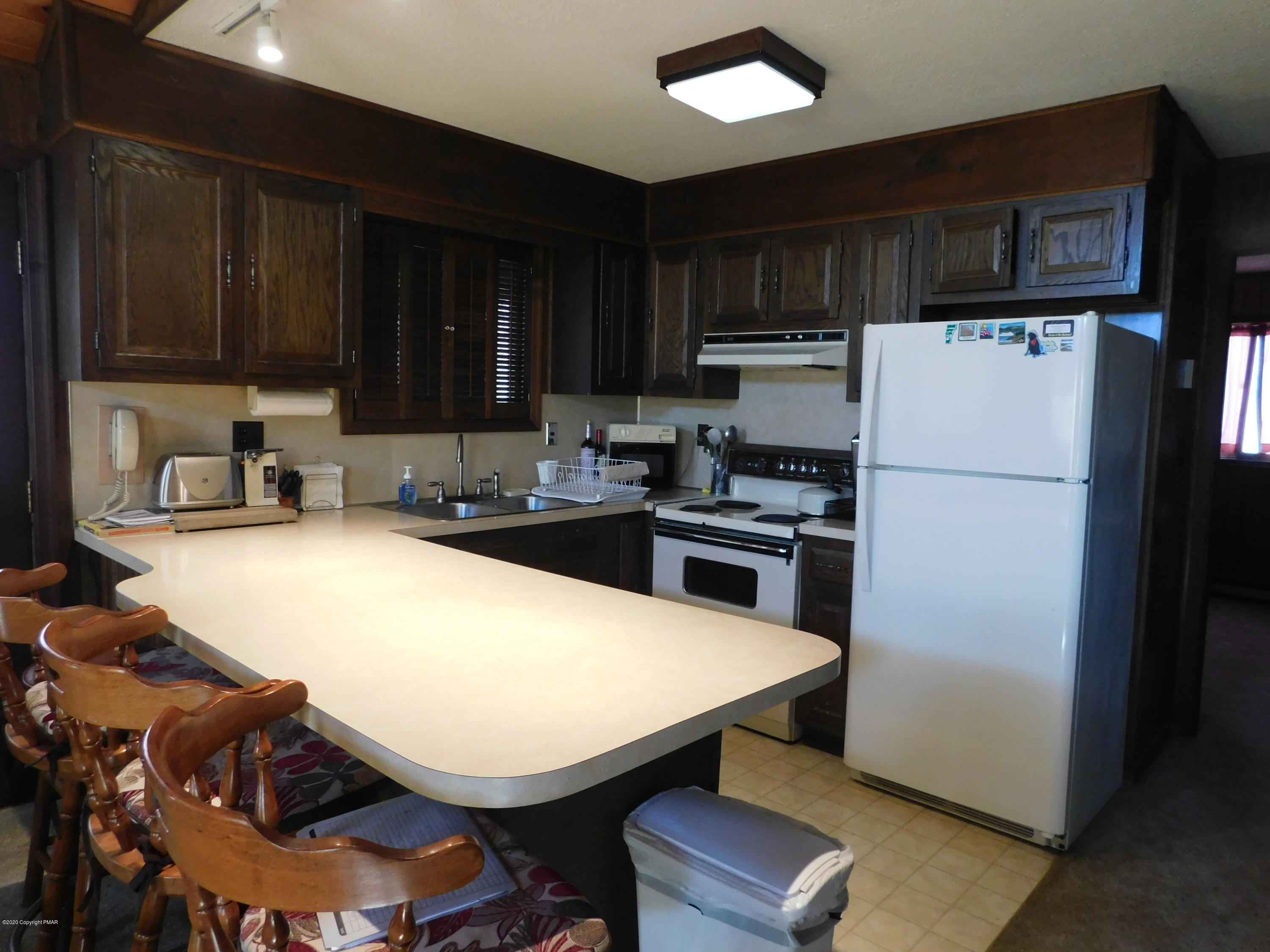 200 Canterbury Road Bushkill, PA 18324 - Photo 31 of 48 a kitchen with stainless steel appliances a refrigerator a stove a sink cabinets and a refrigerator