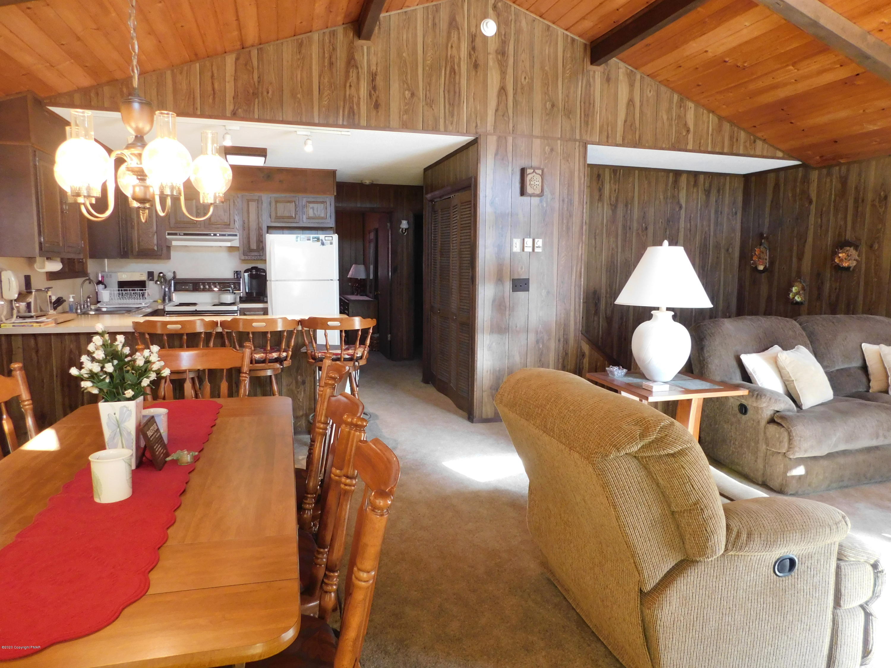 200 Canterbury Road Bushkill, PA 18324 - Photo 47 of 48 a living room with furniture a chandelier and a dining table