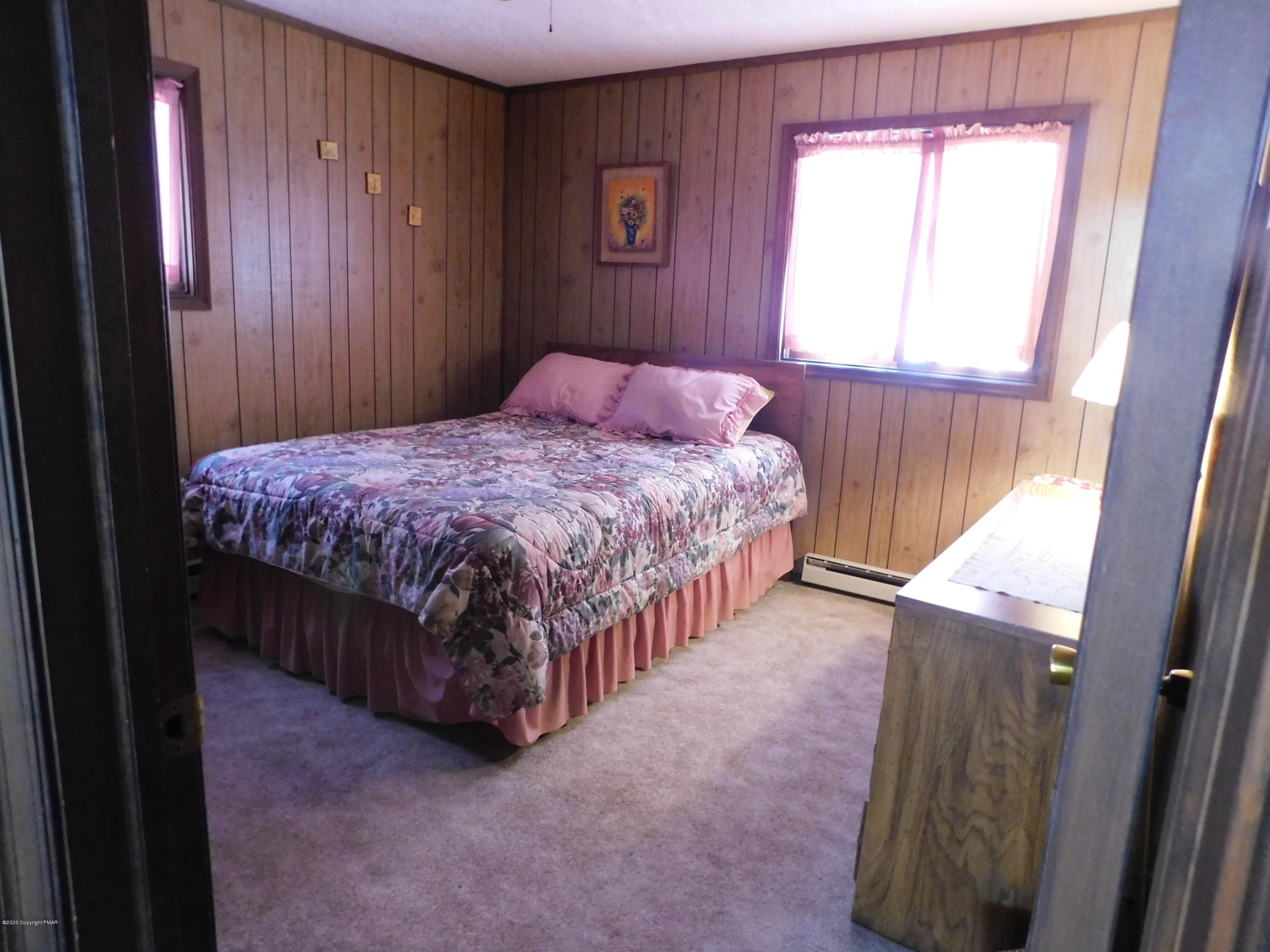 200 Canterbury Road Bushkill, PA 18324 - Photo 6 of 48 a bedroom with a bed window and a wooden floor