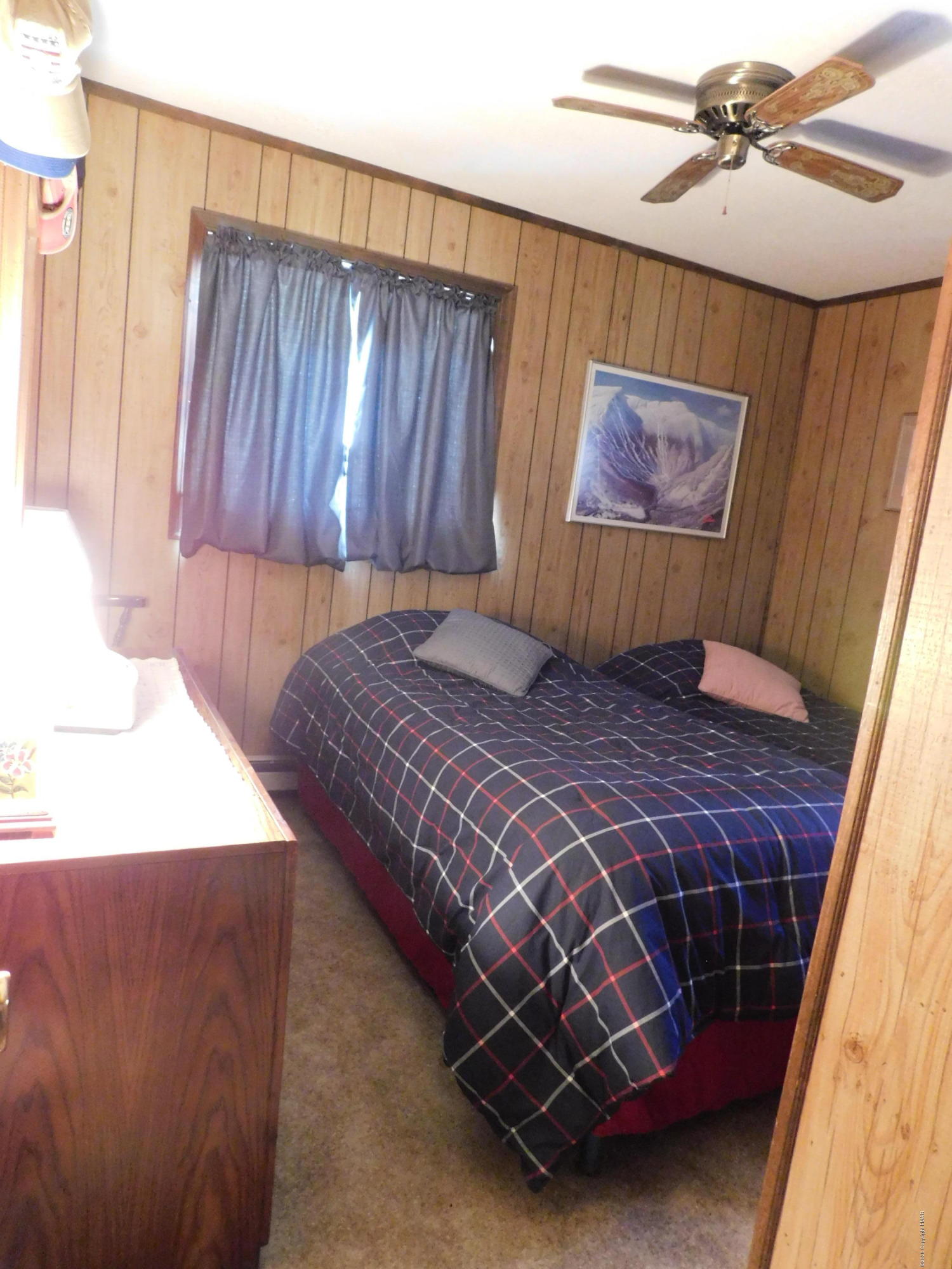 200 Canterbury Road Bushkill, PA 18324 - Photo 7 of 48 a bed sitting in a bedroom next to a window and a chandelier