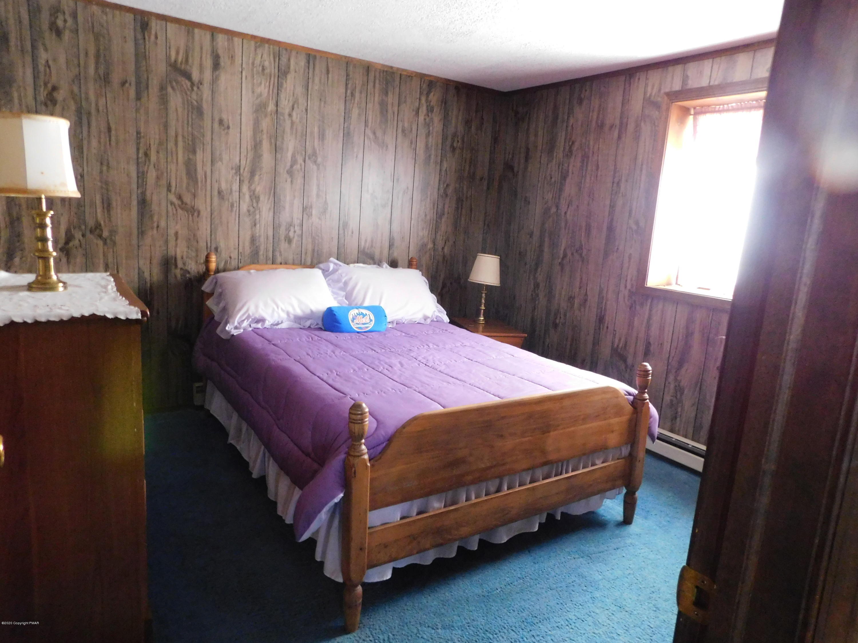 200 Canterbury Road Bushkill, PA 18324 - Photo 8 of 48 a bed sitting in a bedroom next to a window