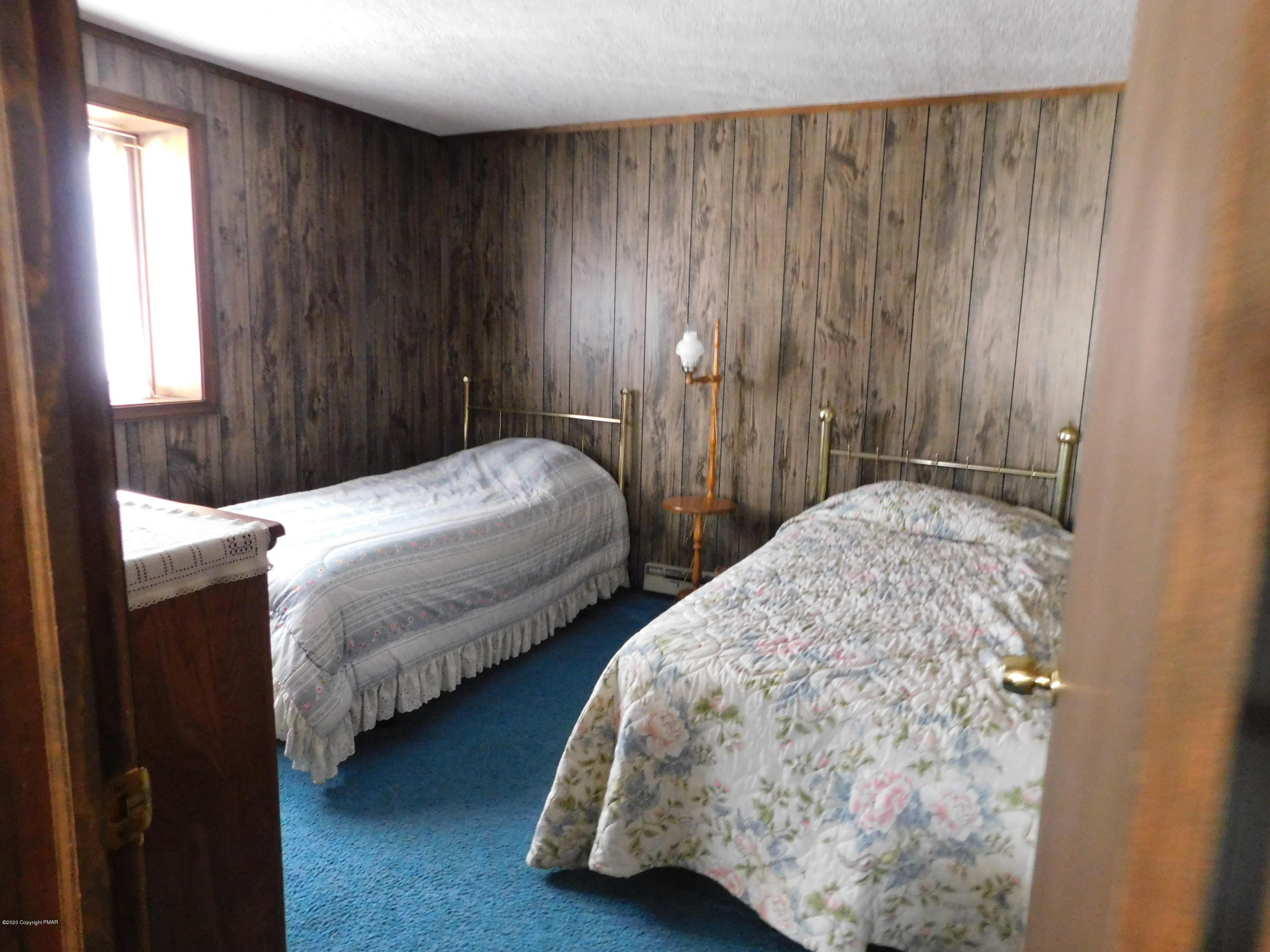200 Canterbury Road Bushkill, PA 18324 - Photo 9 of 48 a bedroom with two beds and a window