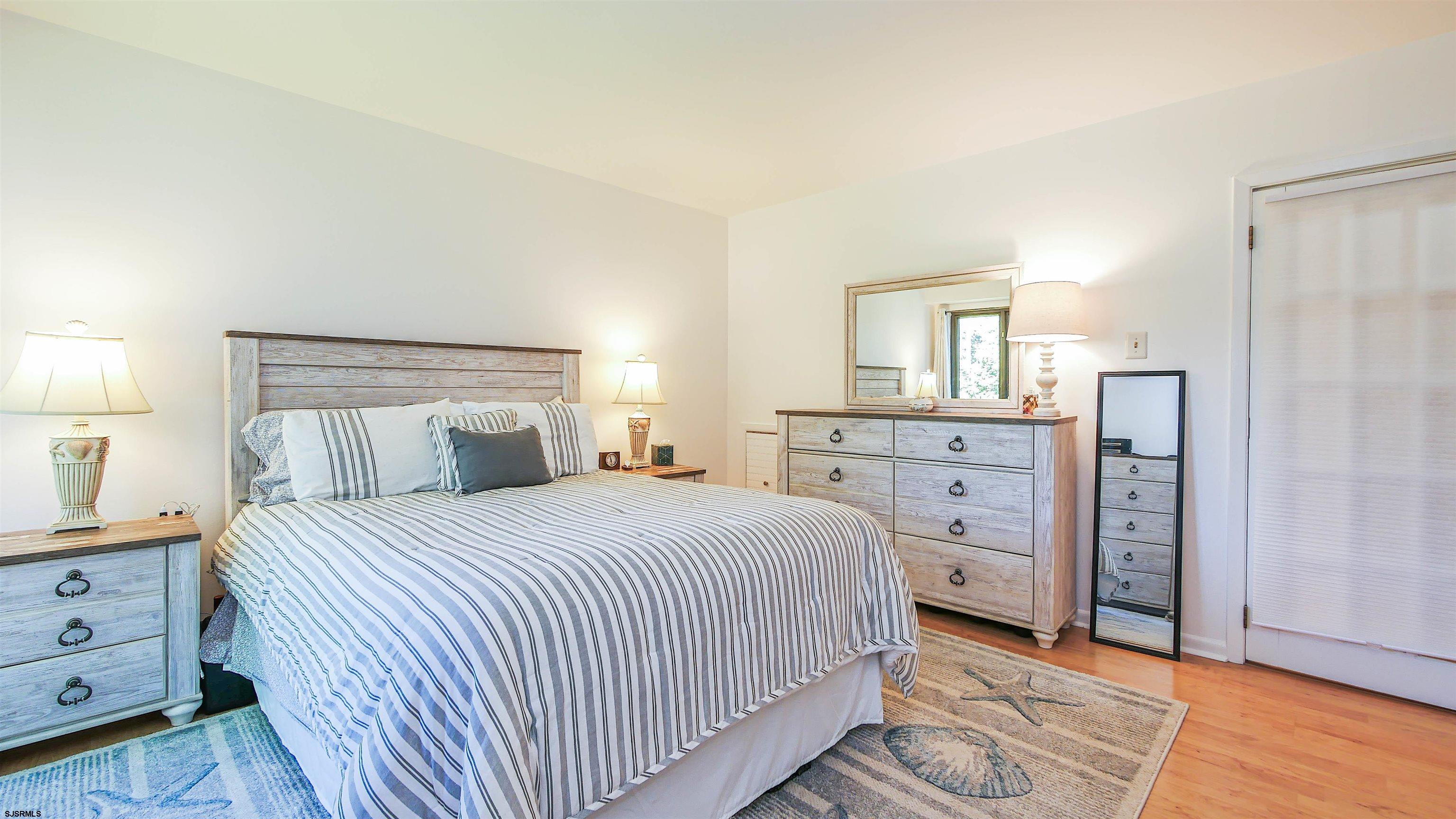 11 Shore Road, Unit 4G Somers Point, NJ 08244 - Photo 27 of 34 a bedroom with a bed and a dresser