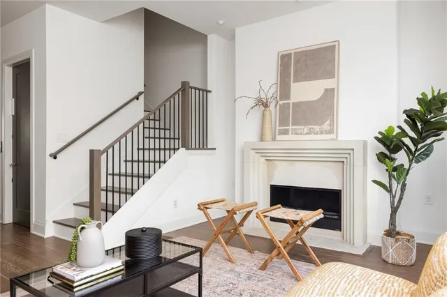 a living room with a fireplace and a potted plant