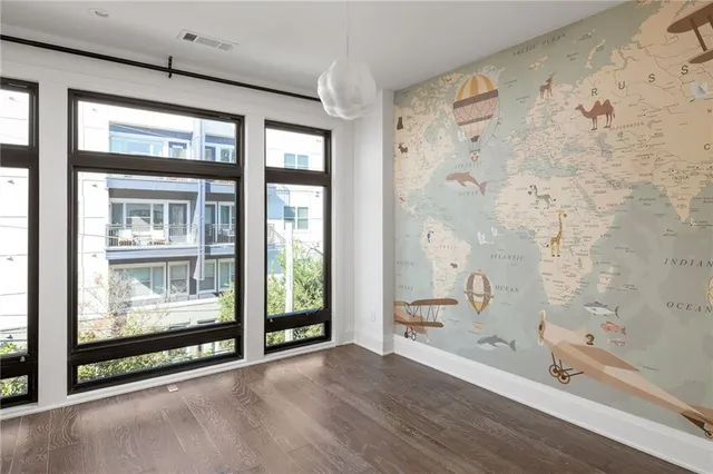a living room with furniture a floor to ceiling window and potted plant
