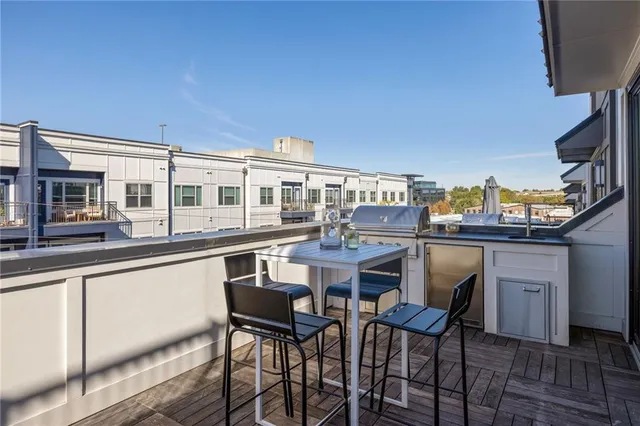 a view of a patio with table and chairs and wooden floor