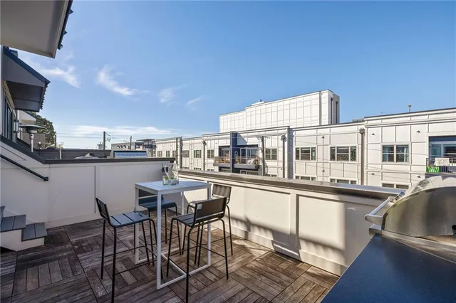 a outdoor dining space with furniture and a flat screen tv