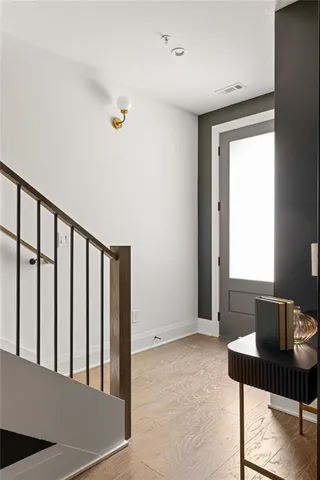 a view of a livingroom with wooden floor and furniture