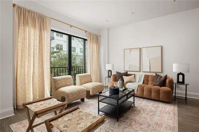a living room with furniture a fireplace and a potted plant