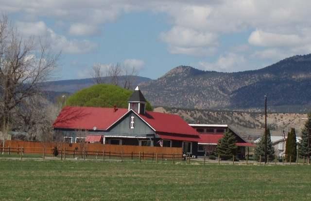 313 225th Road, Unit ANTLERS LANE) Rifle, CO 81650 - Photo 1 of 5 a front view of a house with a garden
