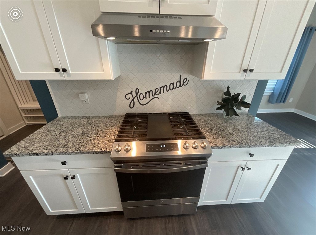 4659 Newcomer Road Kent, OH 44240 - Photo 6 of 23 Kitchen with white cabinets, backsplash, stainless steel range with electric cooktop, and wall chimney range hood