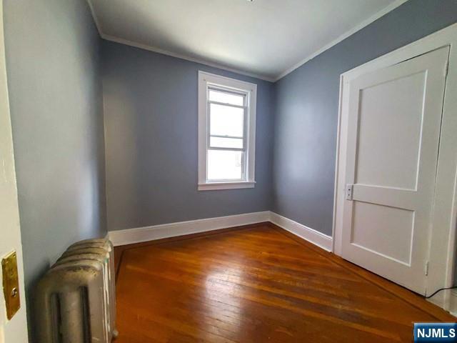 145 Baldwin Street, Unit 2 Bloomfield, NJ 07003 - Photo 11 of 16 a view of empty room with wooden floor and fan