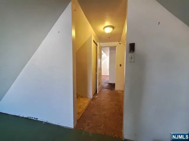 a view of a hallway with wooden walls
