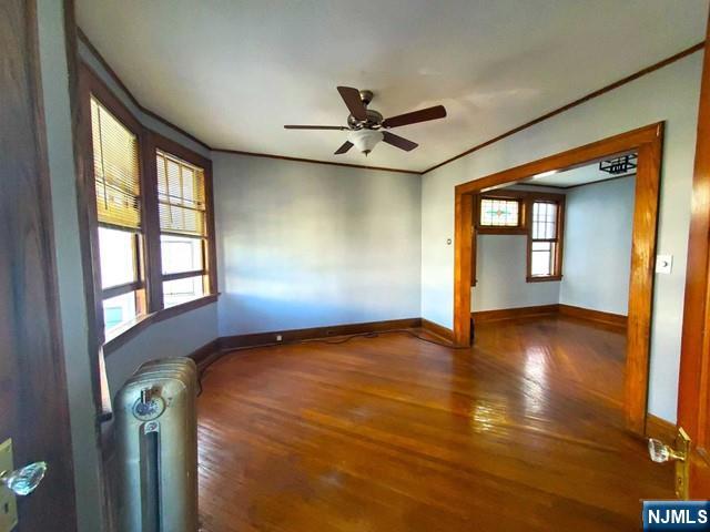 145 Baldwin Street, Unit 2 Bloomfield, NJ 07003 - Photo 5 of 16 a view of an empty room with a window and wooden floor