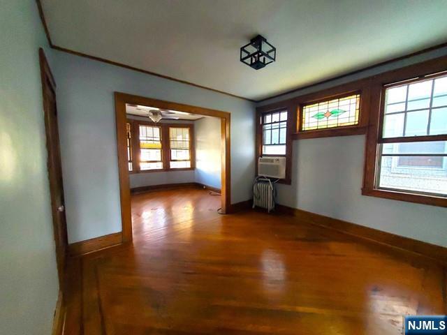 145 Baldwin Street, Unit 2 Bloomfield, NJ 07003 - Photo 6 of 16 an empty room with wooden floor and windows